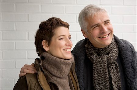 simsearch:6108-05859747,k - Close-up of a mature man arm around a mid adult woman and smiling Stock Photo - Premium Royalty-Free, Code: 6108-05859958
