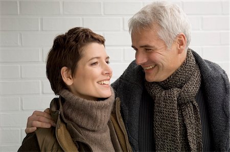 simsearch:6108-05859747,k - Close-up of a mature man arm around a mid adult woman and smiling Stock Photo - Premium Royalty-Free, Code: 6108-05859926