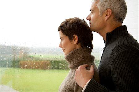 simsearch:6108-05859747,k - Mid adult woman and a mature man looking out through a window Stock Photo - Premium Royalty-Free, Code: 6108-05859929