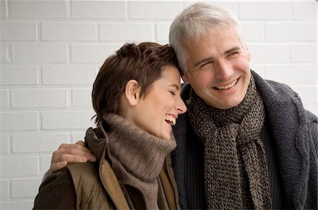 simsearch:6108-05859747,k - Close-up of a mature man arm around a mid adult woman and smiling Stock Photo - Premium Royalty-Free, Code: 6108-05859936