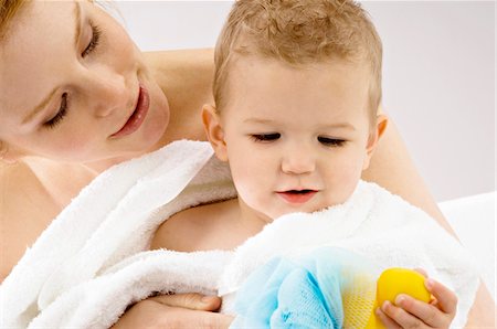 simsearch:6108-05860153,k - Close-up of a young woman wrapping her son in a towel Stock Photo - Premium Royalty-Free, Code: 6108-05860165
