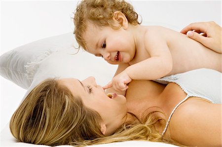 simsearch:6108-05860153,k - Close-up of a young woman lying and playing with her son Stock Photo - Premium Royalty-Free, Code: 6108-05860188