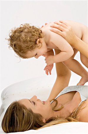 simsearch:6108-05860153,k - Close-up of a young woman lying and playing with her son Stock Photo - Premium Royalty-Free, Code: 6108-05860203