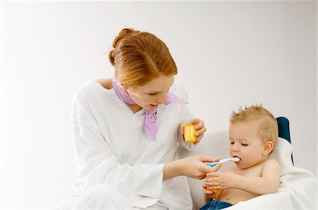 simsearch:6108-05860153,k - Young woman feeding to her son Stock Photo - Premium Royalty-Free, Code: 6108-05860201