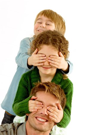 Girl covering eyes of her father and her eyes covered by her brother Stock Photo - Premium Royalty-Free, Code: 6108-05860221