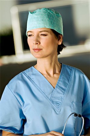 emotional woman looking away - Close-up of a female doctor holding a stethoscope Stock Photo - Premium Royalty-Free, Code: 6108-05860312