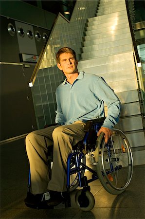 simsearch:6108-05860448,k - Mid adult man sitting in a wheelchair in front of a staircase Foto de stock - Sin royalties Premium, Código: 6108-05860444
