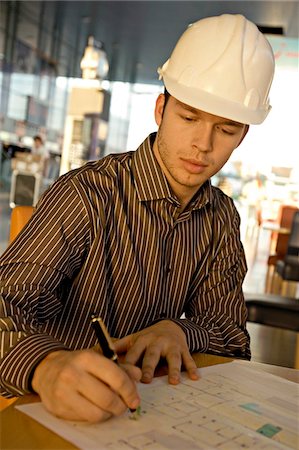 engineer helmet - Male architect working on a blueprint Stock Photo - Premium Royalty-Free, Code: 6108-05860463