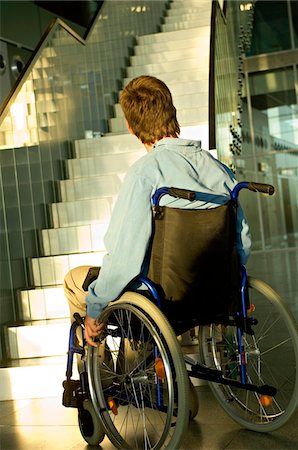 simsearch:6108-05860448,k - Rear view of a mid adult man sitting in a wheelchair and looking at a staircase Foto de stock - Sin royalties Premium, Código: 6108-05860437