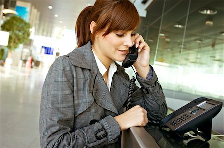 simsearch:6108-05860554,k - Close-up of a businesswoman talking on the telephone at an airport Stock Photo - Premium Royalty-Free, Code: 6108-05860585