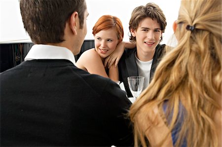 Portrait of a teenage boy with his friends at a dinner party Stock Photo - Premium Royalty-Free, Code: 6108-05860686