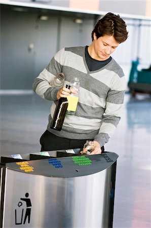 ship in a bottle - Mid adult man putting empty bottles into a garbage bin Stock Photo - Premium Royalty-Free, Code: 6108-05860779