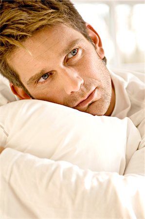 simsearch:6108-05859747,k - Close-up of a mid adult man hugging a pillow Stock Photo - Premium Royalty-Free, Code: 6108-05860796