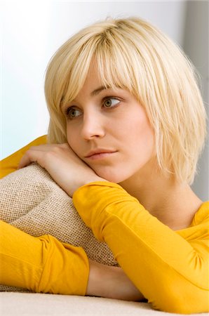 simsearch:6108-05863386,k - Close-up of a young woman hugging a cushion and thinking Stock Photo - Premium Royalty-Free, Code: 6108-05860847