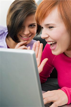 Two young women using a laptop Stock Photo - Premium Royalty-Free, Code: 6108-05861059