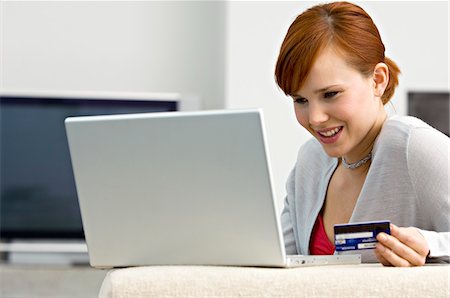 simsearch:6108-05860554,k - Close-up of a young woman holding a credit card and using a laptop Stock Photo - Premium Royalty-Free, Code: 6108-05861035