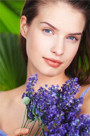 simsearch:6108-05857519,k - Young woman holding lavender sprigs Stock Photo - Premium Royalty-Free, Code: 6108-05861352