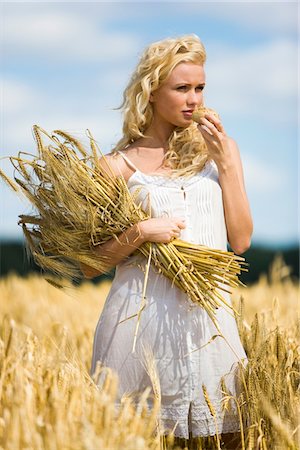 fields picking - Young woman in a wheat field Stock Photo - Premium Royalty-Free, Code: 6108-05861481