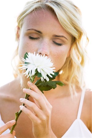 simsearch:6108-05857519,k - Young woman holding a white flower Stock Photo - Premium Royalty-Free, Code: 6108-05861503