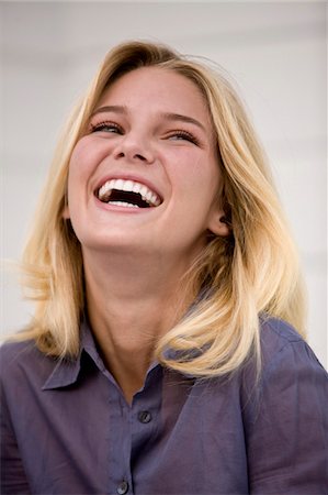 emotional woman looking away - Close-up of a woman laughing Stock Photo - Premium Royalty-Free, Code: 6108-05861850