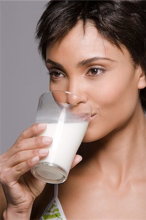 emotional woman looking away - Close-up of a woman drinking milk from a glass Stock Photo - Premium Royalty-Free, Code: 6108-05861919