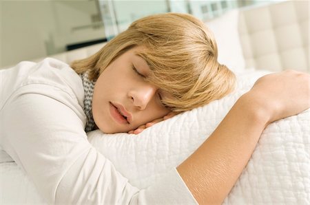 Teenage boy sleeping on the bed Stock Photo - Premium Royalty-Free, Code: 6108-05862585