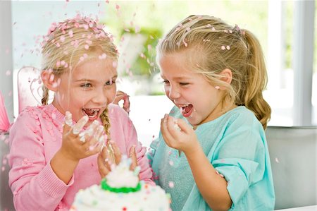 Two girls enjoying a birthday party Stock Photo - Premium Royalty-Free, Code: 6108-05862666