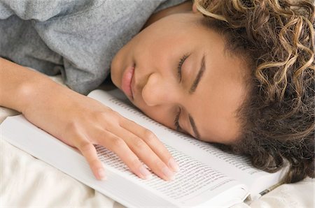 Girl sleeping with her face down on a book Stock Photo - Premium Royalty-Free, Code: 6108-05862602