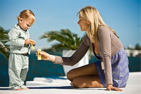 simsearch:6108-05860153,k - Woman holding a soap bubble bottle in front of her son Stock Photo - Premium Royalty-Free, Code: 6108-05862757