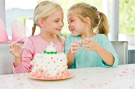 Two girls enjoying a birthday party Stock Photo - Premium Royalty-Free, Code: 6108-05862710