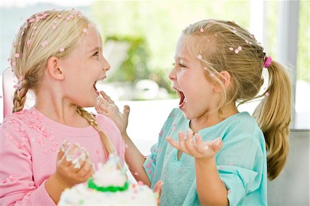 Two girls enjoying a birthday party Stock Photo - Premium Royalty-Free, Code: 6108-05862711