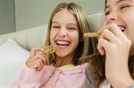 simsearch:6108-05865577,k - Two girls eating chocolate cookies Stock Photo - Premium Royalty-Free, Code: 6108-05862989