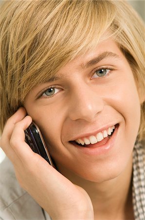 Teenage boy talking on a mobile phone Stock Photo - Premium Royalty-Free, Code: 6108-05862905