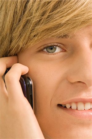 Teenage boy talking on a mobile phone Stock Photo - Premium Royalty-Free, Code: 6108-05862908