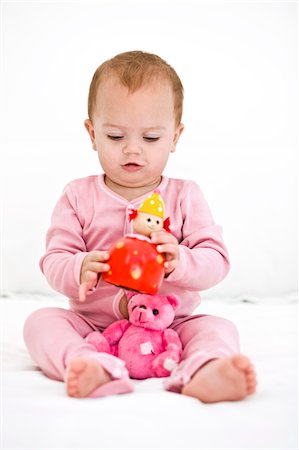 Baby girl playing with toys Stock Photo - Premium Royalty-Free, Code: 6108-05863143