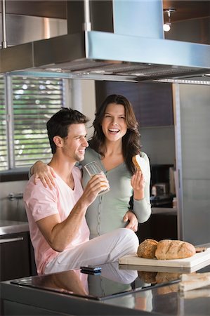 simsearch:6108-05864945,k - Couple having breakfast in the kitchen Stock Photo - Premium Royalty-Free, Code: 6108-05863293