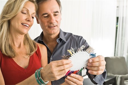 Couple choosing color from a color swatch Stock Photo - Premium Royalty-Free, Code: 6108-05863349