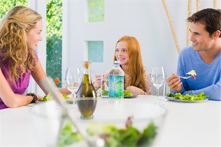 simsearch:6108-05864945,k - Family having lunch and smiling Stock Photo - Premium Royalty-Free, Code: 6108-05863440