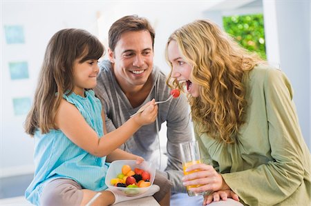 simsearch:6108-05864945,k - Girl feeding fruit salad to her mother Stock Photo - Premium Royalty-Free, Code: 6108-05863452
