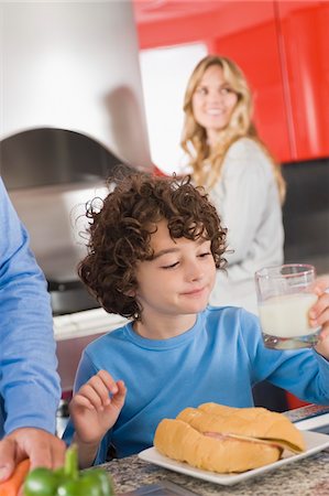 simsearch:6108-05864945,k - Boy having breakfast in the kitchen Stock Photo - Premium Royalty-Free, Code: 6108-05863462