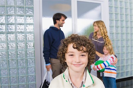 Portrait of a boy with his parents in the background Stock Photo - Premium Royalty-Free, Code: 6108-05863408