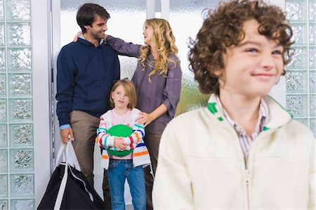 simsearch:6108-05863411,k - Boy smiling with his parents in the background Stock Photo - Premium Royalty-Free, Code: 6108-05863420