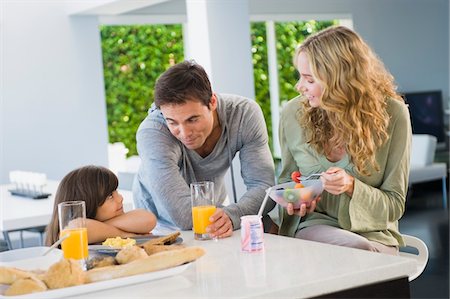 simsearch:6108-05864945,k - Girl with her parents at the breakfast table Stock Photo - Premium Royalty-Free, Code: 6108-05863439