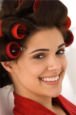 Portrait of a woman with hair curlers in her hair Stock Photo - Premium Royalty-Free, Code: 6108-05863575