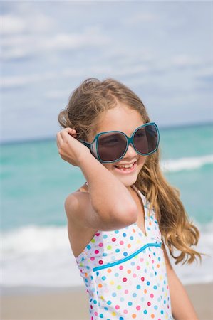 Girl smiling on the beach Stock Photo - Premium Royalty-Free, Code: 6108-05864074