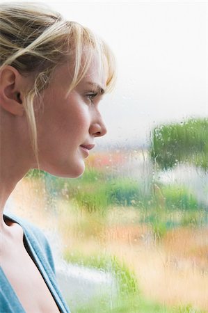 rainy window - Close-up of a woman thinking Stock Photo - Premium Royalty-Free, Code: 6108-05864253