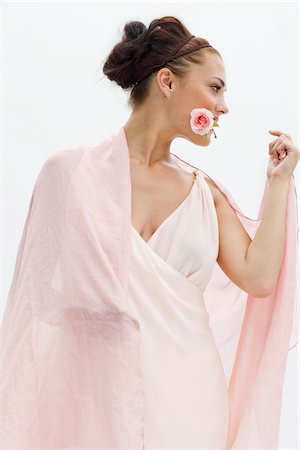 simsearch:877-07460478,k - Fashion model holding rose between her teeth Stock Photo - Premium Royalty-Free, Code: 6108-05864330