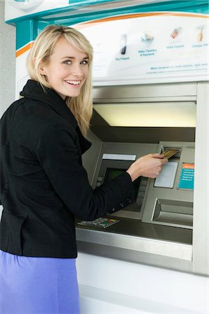 simsearch:6108-05860554,k - Woman inserting a credit card into ATM Stock Photo - Premium Royalty-Free, Code: 6108-05864598