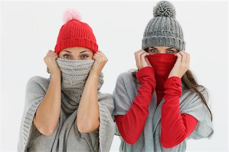 Portrait of two women hiding their faces Stock Photo - Premium Royalty-Free, Code: 6108-05864885