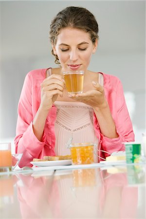 simsearch:6108-05864945,k - Woman having breakfast at a table Stock Photo - Premium Royalty-Free, Code: 6108-05864979